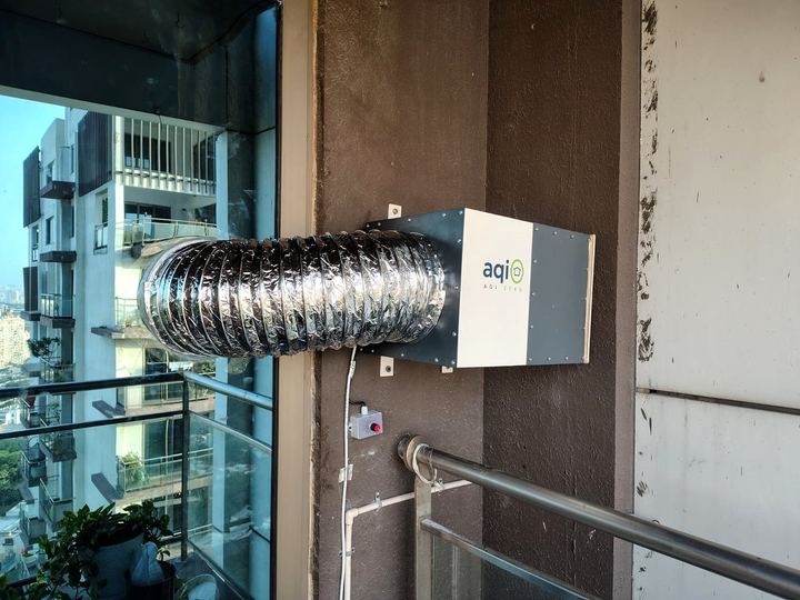 aqi0 unit on a high-rise balcony wall