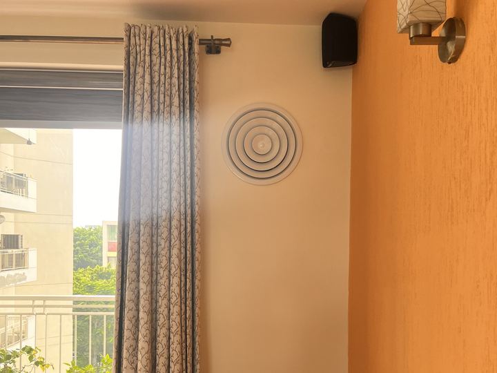 Round aqi0 diffuser on a living-room wall